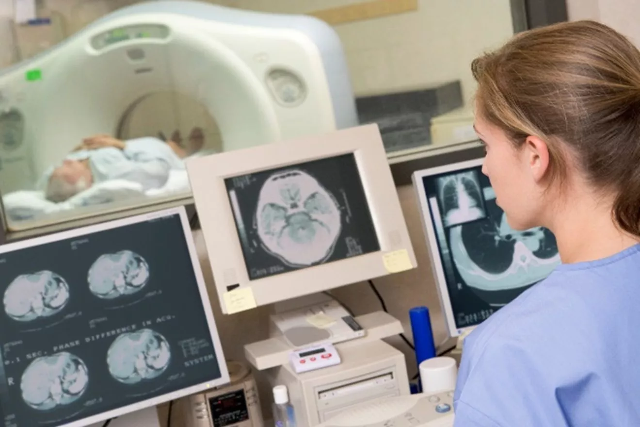 A medical technician performing a CT scan on a patient